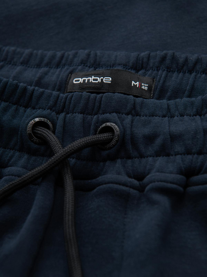 Spodnie męskie dresowe z prostą nogawką i gumowymi detalami – ciemnoniebieskie V2 OM-PASK-0281