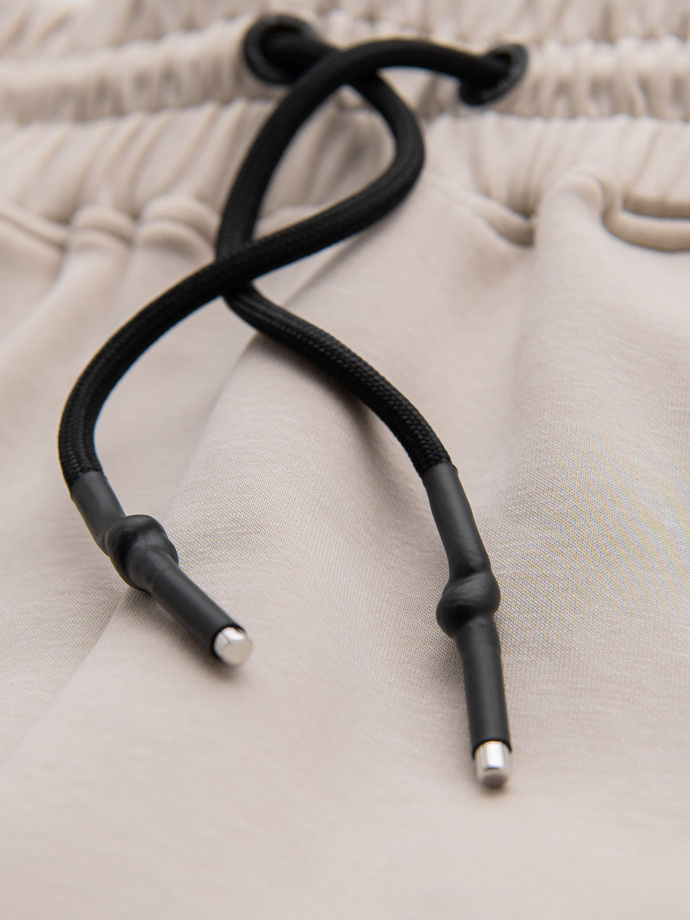 Męskie spodnie dresowe ze ściągaczami i ozdobnym zamkiem – piaskowe V6 OM-PASK-0226