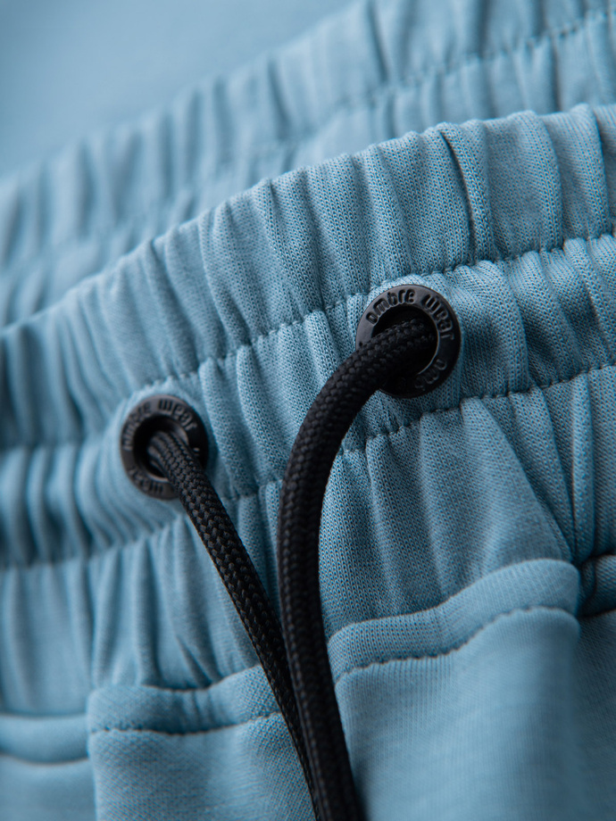 Men's sweatpants with ribbed cuffs and decorative zipper - light blue V4 OM-PASK-0226