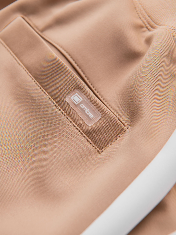 Męskie dresowe spodnie joggery z kontrastowymi lampasami – beżowe V4 OM-PASK-0229