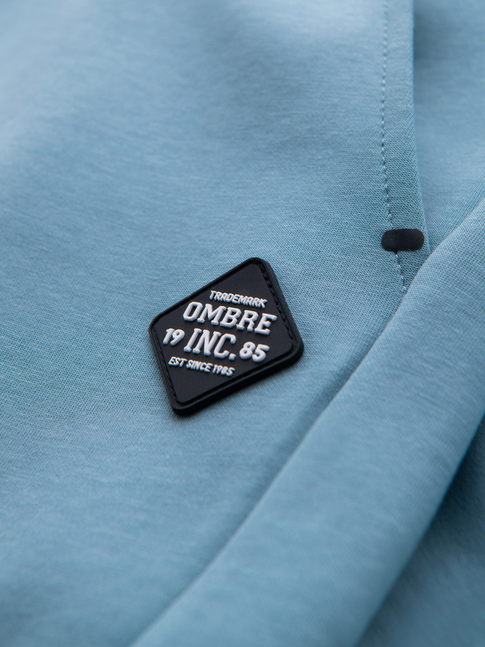 Spodnie dresowe męskie ze ściągaczami i ozdobnym zamkiem – jasnoniebieskie V4 OM-PASK-0226