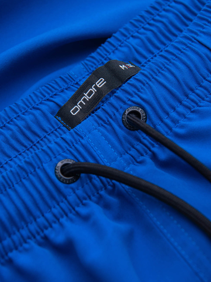 Neonowe męskie szorty kąpielowe z efektem magic print – niebieskie V3 OM-SRBS-0147